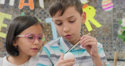 Children painting easter eggs, happy easter garland background Stock Footage 232946936