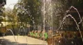 Children with parents walking in central park. Sunny day in city. Family weekend HD Footage