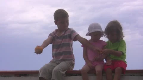 Children peel the orange fruit Stock Footage 10576775