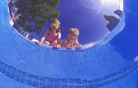 Children Peering Into A Pool Stock Photos