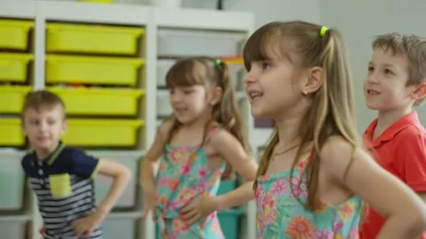 Children perform exercises between lessons, move and jump. Stock Footage 251527643