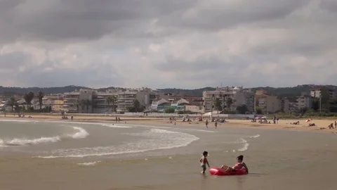 Children play, bathe and rest on the beach. Stock Footage 75558393