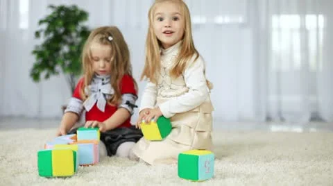 Children play with blocks of tissue. They learn the alphabet sitting on the c Video stock 8956827
