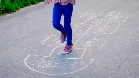 Children play classics jumping on the asphalt. Selective focus. Stock Footage 155006993