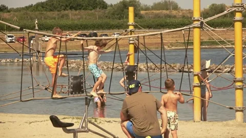 Children play on the climbing frames on the beach Video stock 254802841