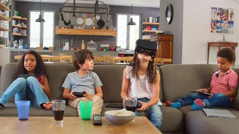 Children Play Computer Game Using Virtual Reality Headset Stock Photos
