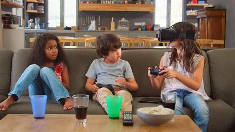 Children Play Computer Game Using Virtual Reality Headset Stock Photos