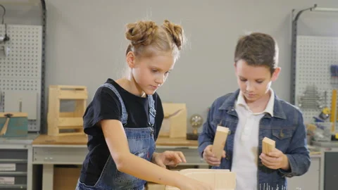 Children play at craft workshop. Cute little boy and his school-aged sister Stock Footage 102276071