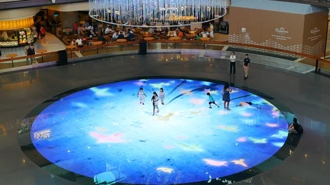Children play on Digital Light Canvas inside The Shoppes in Singapore Stock Footage 110920198