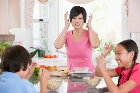 Children play fight while having breakfast Stock Photos