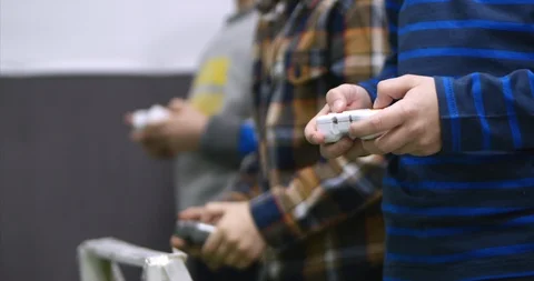 Children play in games using the game controller. Wireless game controler. Stock Footage 93849981