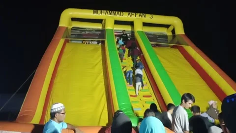 Children play the highest slide cheerfully Stock Footage 219695427