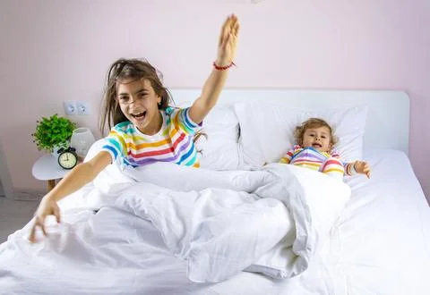 Children play jumping in bed. Selective focus. Foto stock