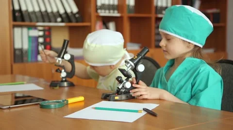 Children play with a microscope Stock Footage 60750026