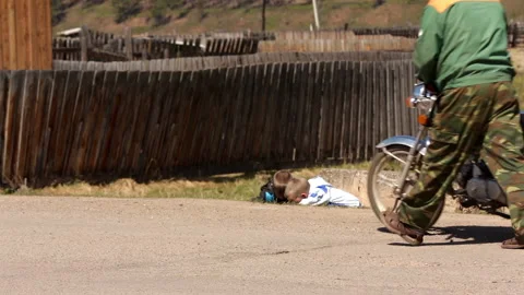 Children play near the road in a small Siberian village. Stock Footage 246117853