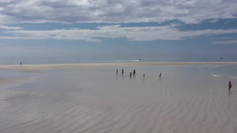 Children play by the ocean. Sandy beach and family holidays. Stock Footage 166113724