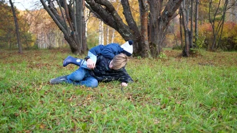 Children play in the Park,run, fall to the ground. Laughter and joy for the Stock Footage 143336208