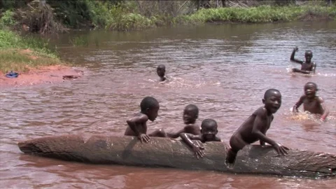 Children play on a pirogue Stock Footage 80475377