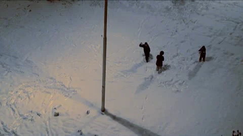Children play in the snow at night Stock Footage