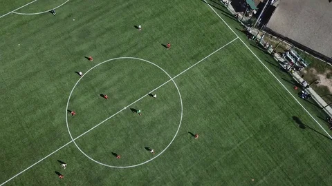 Children play soccer on the football field top view version 2 Stock Footage