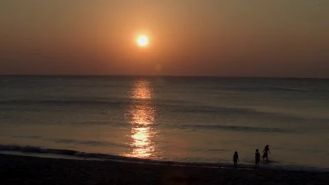 Children Play in the Surf at Sunset, Phuket, Thailand Stock Footage 84539978