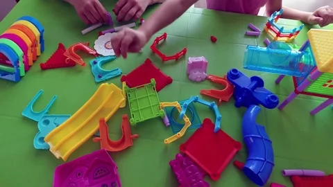 Children play at the table with a building kit Stock Footage 79618122