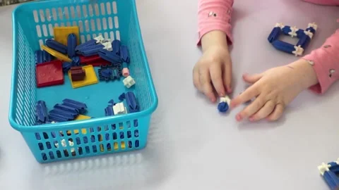 Children play on a table with a lego set 動画素材 201251580