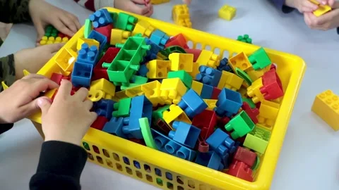 Children play on a table with a lego set Stock Footage 201251610
