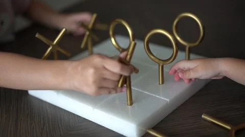 Children play tic-tac-toe made of metal and stone Stock Footage 220829418