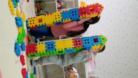 Children play together as a constructor build a house. Selective focus. Stock Footage 172549680