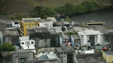 Children play on top of crypts Stock Footage 12453077