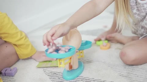 Children in a playful way learn the composition of the number of the house Stock Footage 134587799