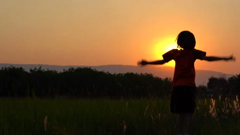 Children playing and exercise on sunrise background for joy and relax on field Stock Footage 150888667