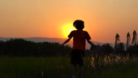 Children playing and exercise on sunrise background for joy and relax on field Видео 150888701