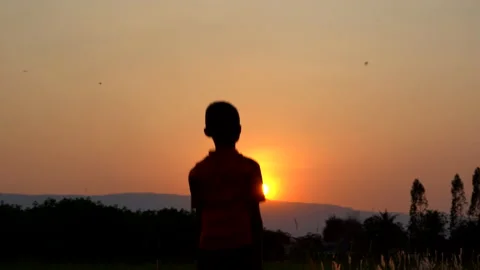 Children playing and exercise on sunrise background for joy and relax on field Stockbeeldmateriaal 150888831