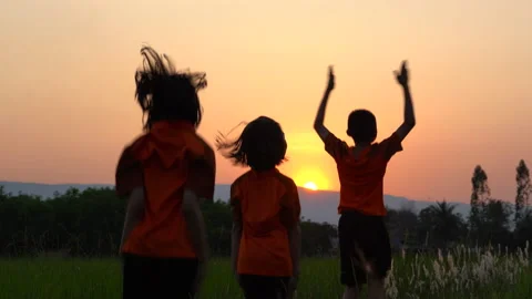 Children playing and exercise on sunrise background, kids group joy and relax Видео 150889146