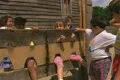 Children playing and sitting inside stocks at historic site Footage