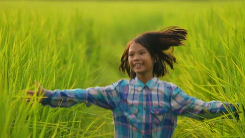 Children playing and spread out hands touch green leaf of rice field organic  Stock-Footage 219079883