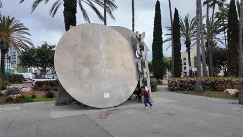 Children playing around the Breaking the Chains sculpture in Martin Luther King Stock Footage 338183125