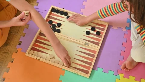 Children playing backgammon on colorful foam play mat Stock Footage 290052047