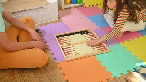Children playing backgammon on colorful foam floor tiles Stock Footage 290052186