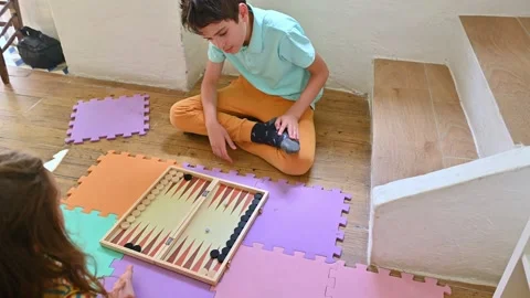 Children playing backgammon on colorful foam mats indoors Stock Footage 290052308