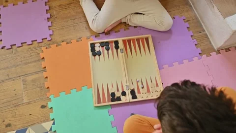 Children playing backgammon on colorful foam mats indoors Stock Footage 290053064