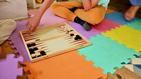 Children playing backgammon on colorful foam mats indoors Stock Footage 290053072
