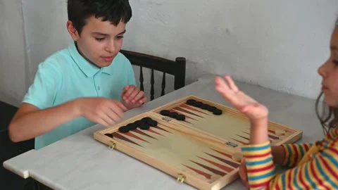 Children playing backgammon with focus and concentration Stock Footage 290050592