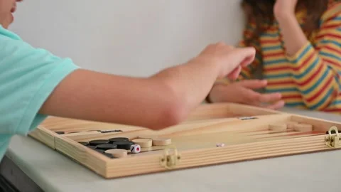 Children playing backgammon with focus on game board Stock Footage 290051950