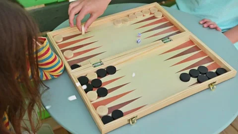 Children playing backgammon game on a wooden board outdoors Stock Footage 290053567