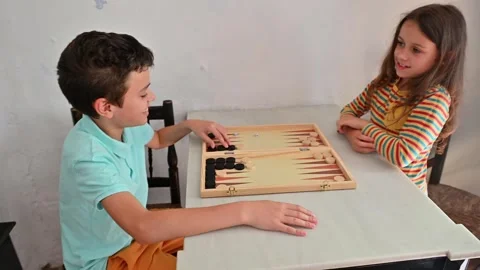 Children playing backgammon at home on a casual afternoon Stock Footage 290051699