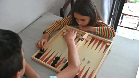 Children playing backgammon at home for fun and learning Stock Footage 290050849