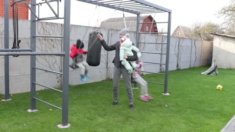 Children playing in the backyard with mother Stock Footage 143712544